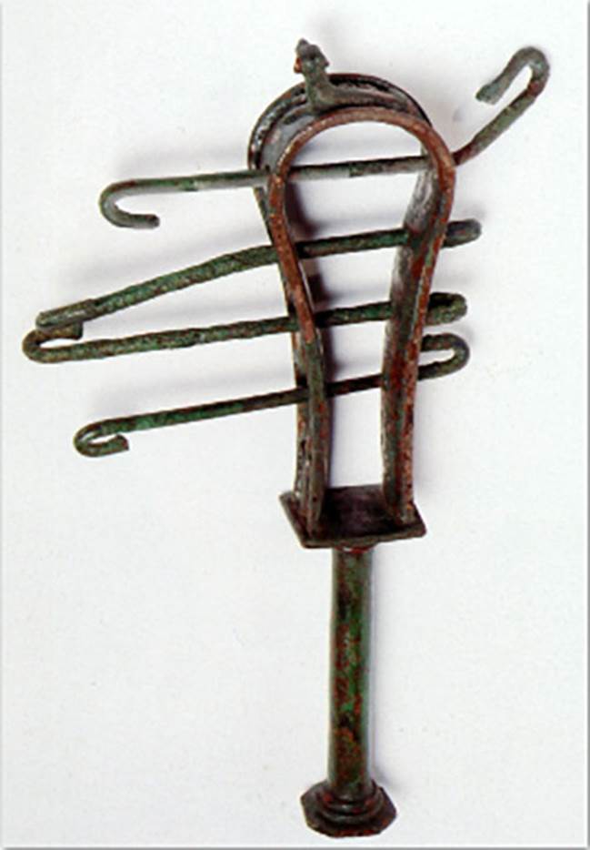 VIII.7.28 Pompeii. The instrument was found on January 4th, 1766 in the Ekklesiasterion.
The sistrum is adorned on the top with a crouched cat and on the sides with lotus flowers. 
It was found together with some marble fragments of limbs, among which some of the hand that originally held it and of a marble head of Isis.
Now in Naples Archaeological Museum. Inventory number 2397.
Now in Naples Archaeological Museum. Inventory number 409AE.