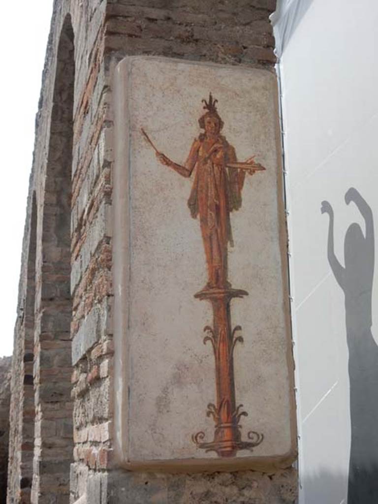 VIII.7.28 Pompeii. May 2017. Reproduction fresco on south side of central arch in the Ekklesiasterion.
Priestess on a candelabrum carrying offerings on a tray. 
Now in Naples Archaeological Museum. Inventory number 8917.
Photo courtesy of Buzz Ferebee.