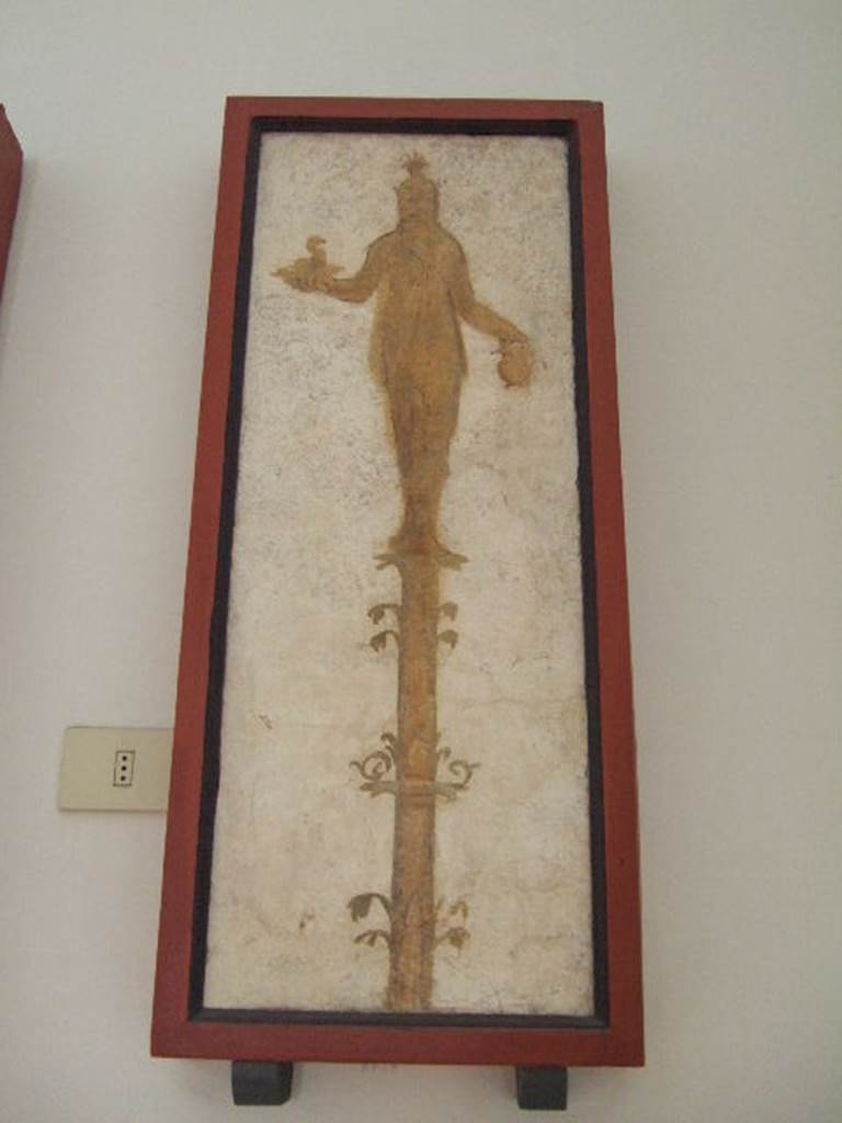 VIII.7.28 Pompeii.  Priestess on a candelabrum with a cobra and jar.  
Found in passageway of arch.  Now in Naples Archaeological Museum.