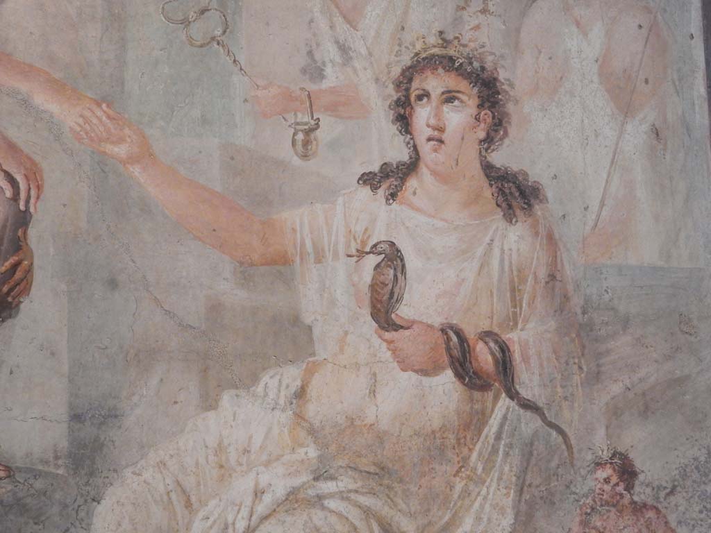 VIII.7.28 Pompeii. June 2019. Detail of Isis offering her right hand to Io and holding a cobra in her left.  
Found in the centre of the south wall of the Ekklesiasterion in November 1765. 
Now in Naples Archaeological Museum. Inventory number 9558.  Photo courtesy of Buzz Ferebee.