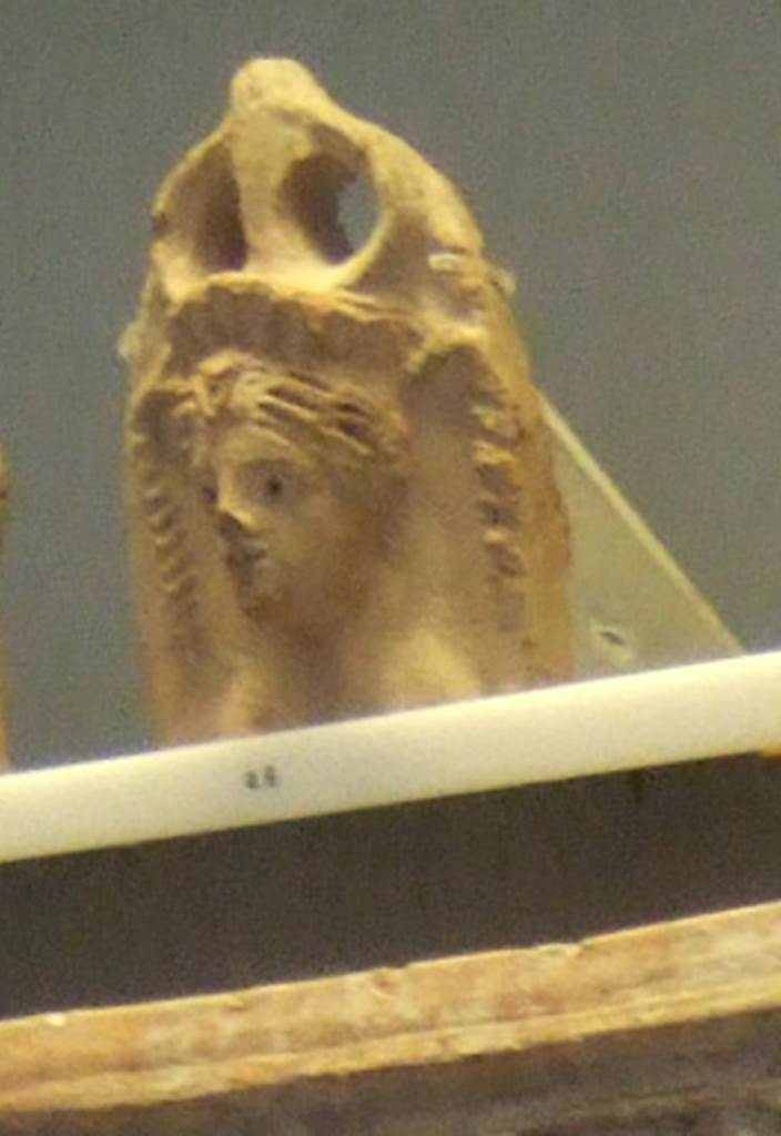 VIII.7.28 Pompeii. Egyptian styled antefix with female bust, with naked breasts, and wearing a diadem. 
Similar figures modelled in stucco were found on the walls of the purgatorium.