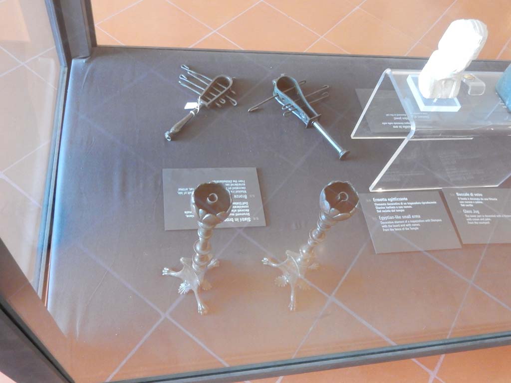 VIII.7.28 Pompeii. June 2019. Found in another wooden box in the temple cella. Two similar but not identical bronze candelabra. 
Now in Naples Archaeological Museum. Inventory numbers 72192 and 72193. Photo courtesy of Buzz Ferebee.