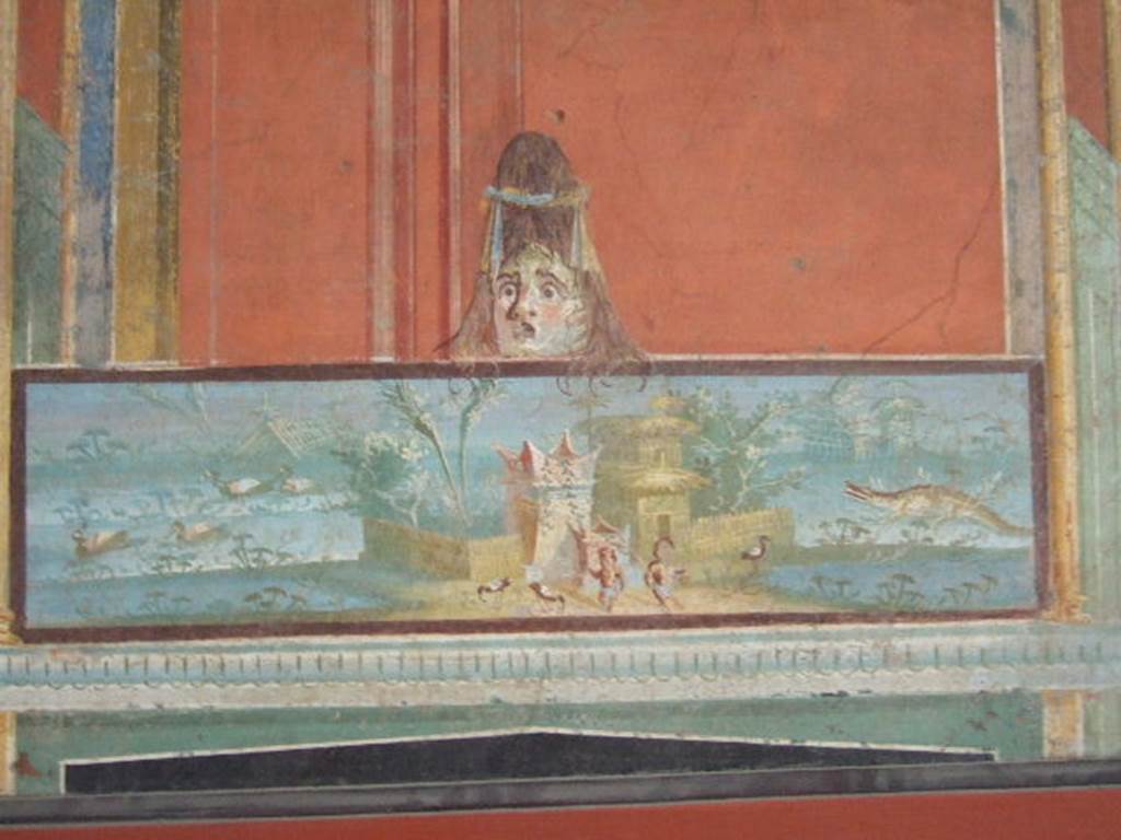 VIII.7.28 Pompeii. From the left of the east wall of the portico. 
Detail of Nilotic scene with two pigmies and surmounted by a female theatrical mask. 
Now in Naples Archaeological Museum. Inventory number 8607.