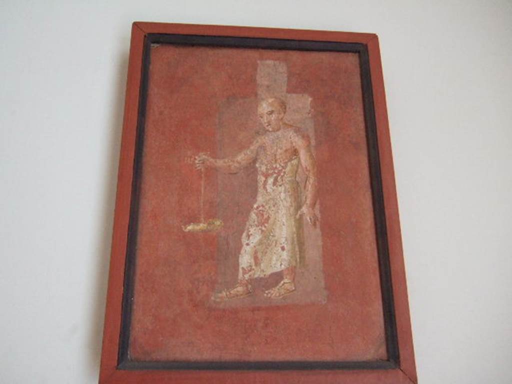 VIII.7.28 Pompeii. Priest carrying oil lamp, found on feature on right part of south wall. 
Now in Naples Archaeological Museum. Inventory number 8969.