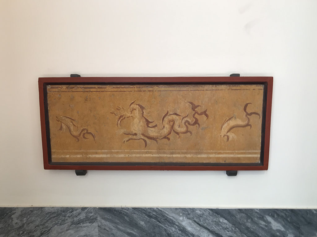 VIII.7.28 Pompeii. April 2019. Zoccolo from right part of east portico. Painting of marine dragon between dolphins. 
Now in Naples Archaeological Museum. Inventory number 8874.
Photo courtesy of Rick Bauer.