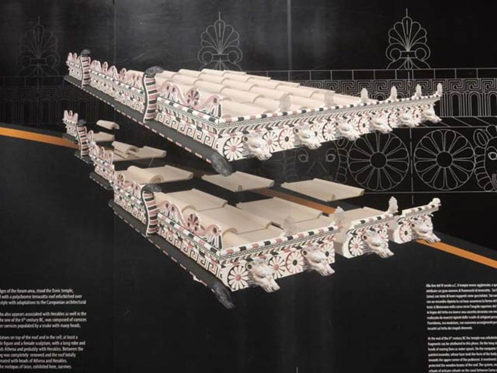 VIII.7.31 Pompeii, May 2018. Roof reconstruction drawing from information notice-board. 
On the long side ran a cornice (sima) with the heads of roaring lions as waterspouts.
On the ramparts was a flat band with a painted meander whose base took the form of the body of a snake with heads facing towards the upper corner of the pediment.
A revetment plaque with guilloche (an engraved pattern of spirals, intertwining bands etc.) in relief protected the wooden beams of the roof.
Photo courtesy of Buzz Ferebee.