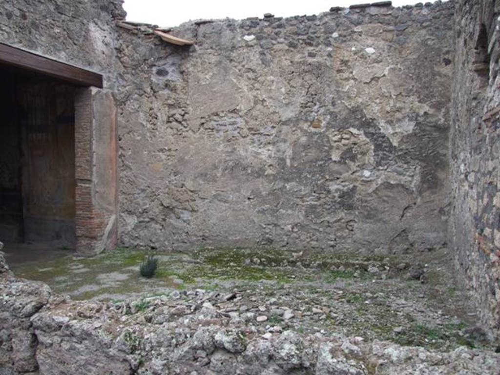 IX.1.7 Pompeii. December 2007. Garden area, looking north. According to Jashemski, 
“the small garden to the left of the atrium had a raised planting bed attached to the wall at the edge of the garden, on the east and on much of the north wall. The low wall with space for plants continued on the south side, separating the garden from the atrium. The house was small but well decorated. Two marble tondi (Naples inventory 109 288, and 6622) were found in the garden; the marble Herm of Bacchus (Naples inv. 109 518) and the marble Statuette of Attis attached to a little support (Naples inv. 120 402), as well as 2 marble pine-cones (fountains ?) may have been garden decorations. The triclinium on the west opened onto the garden. There was also an entrance doorway to the garden from the atrium”.
See Jashemski, W. F., 1993. The Gardens of Pompeii, Volume II: Appendices. New York: Caratzas. (p.225)
According to Lucia Anna D’Acunto, the following marble objects were found in this garden, atrium and second room to the left. Marble disc (Oscillum), found in garden on 21.4.1857, Naples Inventory number 6622. White marble decorative shield (Clipeo) found in garden on 2.8.1871, Naples inventory number 109288. Herm of Dionysius, found in second room to the left on 28.5.1866, Naples inventory number 109518. Table support (Trapezoforo) of a young boy with phrygian cap, found in atrium on 3.5.1866, Naples inventory number 120402.
See Pompeian marble in the Naples Museum (SAP book 26), by Carrella, A; D’Acunto, L.A; Inserra, N; and Serpe, C. (p.160-2)