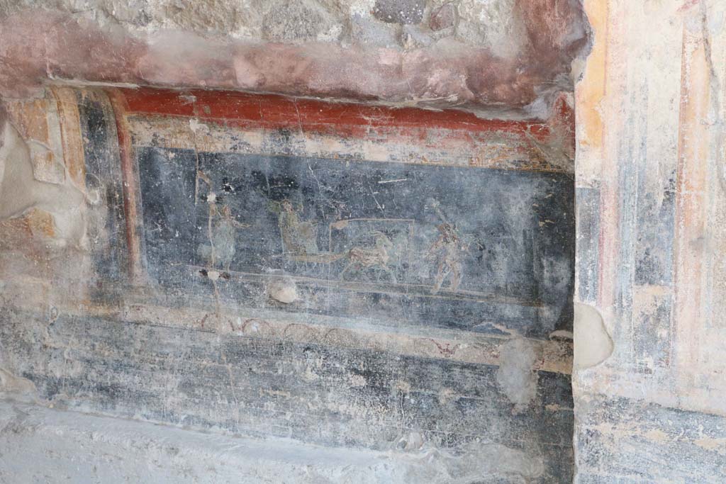 IX.1.7 Pompeii. December 2018. 
Above the black zoccolo, in the predella is a painting showed a Psyche in a cart pulled by two goats and being led by a cupid, whilst another Psyche, wearing a green robe, followed it. Photo courtesy of Aude Durand.