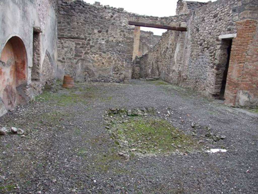 IX.1.7 Pompeii. December 2007. Atrium, looking west across impluvium towards entrance corridor. According to Fiorelli, the latrine and the stairs can be seen in the entrance corridor.
.