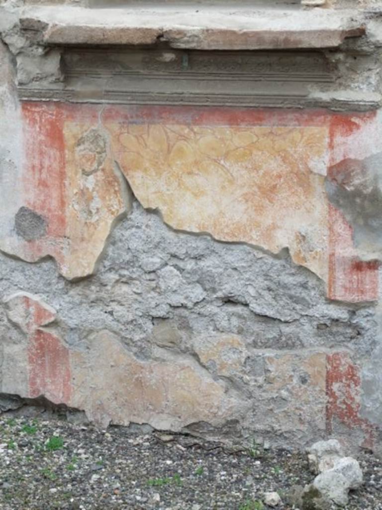 IX.1.7 Pompeii. December 2007. Painted wall, under the heavy masonry ledge above the panel painted to represent a block of red and yellow variegated marble, bordered in red.