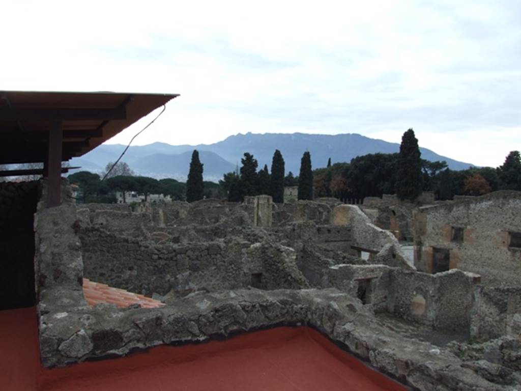 IX.1.20 Pompeii.  December 2007.  Room 16.  View from upper floor.
Looking south west towards the corner of IX.1.15/16 and the wall of the Stabian Baths on Via Stabia, on the right.