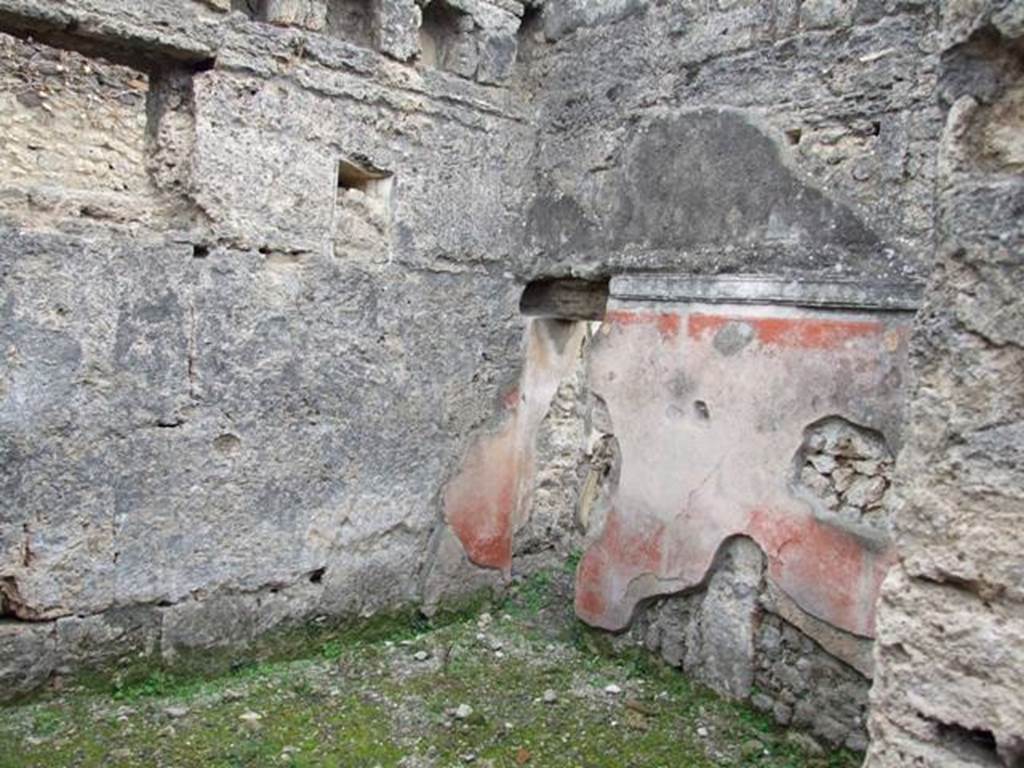 IX.1.22 Pompeii. December 2007. Room 17, cubiculum. On the left, in the east wall, are two windows; the smaller one was blocked up and substituted by the square larger one.
Above the windows, the square holes for the upper floor support beams can be seen.
At the east end of the south wall is the doorway leading under the stairs. On the south wall, the high zoccolo/plinth was painted red separated by a narrow white band and crowned with a moulded stucco cornice. The upper part of the wall was rough plaster. On the west wall, graffitied accounts were noted.