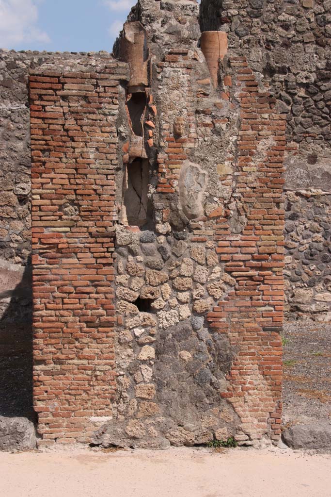 IX.2.3 Pompeii, on right. September 2021.
Looking east to pilaster with downpipes between IX.2.2, on left, and IX.2.3, on right. 
Photo courtesy of Klaus Heese.