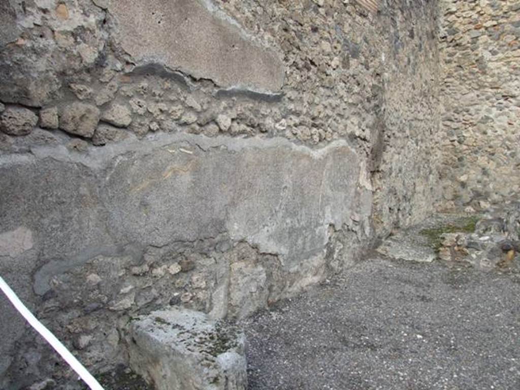 IX.2.6 Pompeii. December 2007. North wall of shop. Looking towards small room or kitchen. In front of the doorway to the small room would have been the stairs to the upper floor.