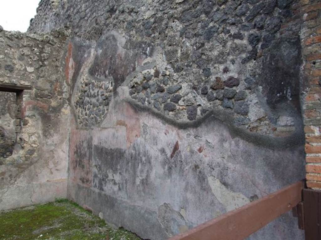 IX.2.12 Pompeii. December 2007. South wall of shop. According to PPP, on this south wall the zoccolo was red, the central panel of the middle zone was red and the side panels were faded and discoloured. 
See Bragantini, de Vos, Badoni, 1986. Pitture e Pavimenti di Pompei, Parte 3. Rome: ICCD. (p.412)