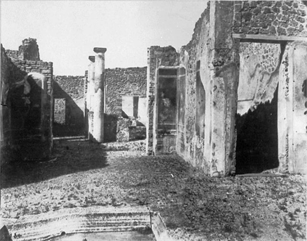 IX.2.18 Pompeii. Old undated photograph of room 5, tablinum, looking into garden area.
This old photograph shows the two flying cupids at the sides of the doorway to the garden.
On the right is a corridor from the atrium to the garden.