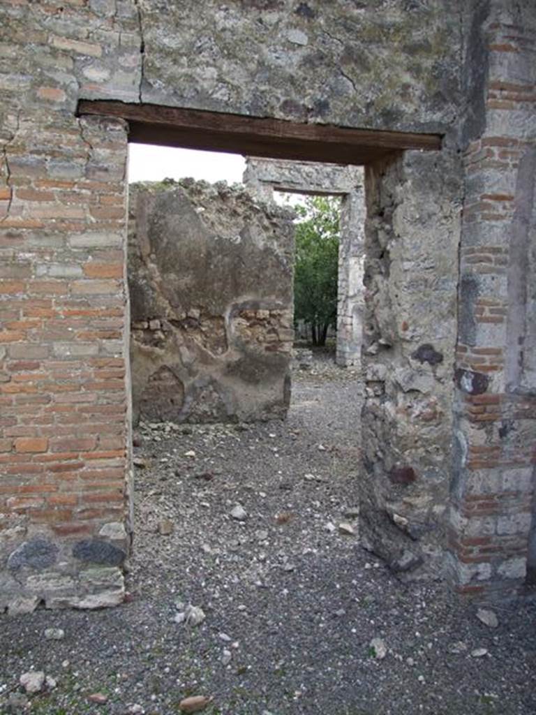 IX.2.21 Pompeii. March 2009. Doorway to room 5, a triclinium, from the atrium.  According to Sogliano, found in the room on the right of the tablinum, on the entrance wall, was a  mythological painting. It showed a young man, crowned with leaves, with a blue mantle, sitting on a rock, extending his left arm towards a standing baccante, as if to attract her to him. She was dressed in a green chiton with a violet mantle, and holding a long stick.
See Sogliano, A., 1879. Le pitture murali campane scoverte negli anni 1867-79. Napoli: Giannini. (p.127, no.621)