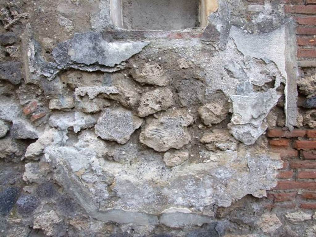 IX.2.24 Pompeii. March 2009. West wall under niche. Lower part of Lararium painting.  One very small part of a serpent is all that can still be seen. 
See Fröhlich, T., 1991, Lararien und Fassadenbilder in den Vesuvstädten.  Mainz: von Zabern.  (L99: p.293, T. 42, 3). 
According to Boyce, in the lower zone a large serpent advanced from the right towards an altar furnished with offerings. Across the top of the whole painting was stretched a garland.
See Boyce G. K., 1937. Corpus of the Lararia of Pompeii. Rome: MAAR 14. (p. 82, no. 403 and Pl. 24, 2.)