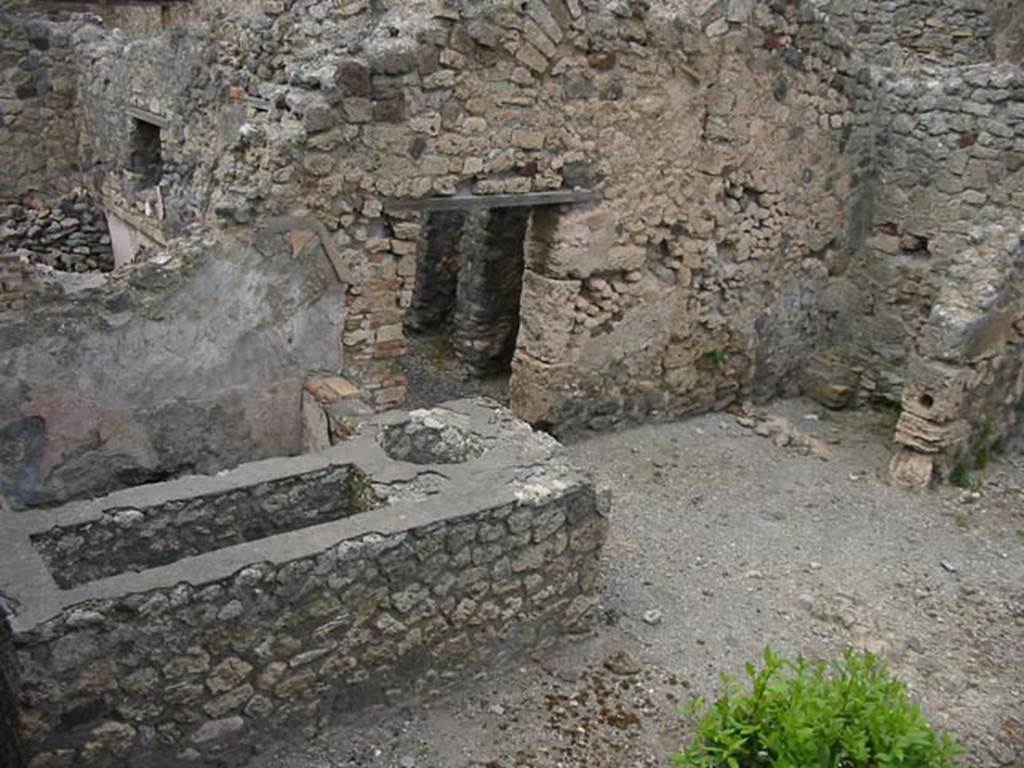 IX.2.24 Pompeii. May 2003. Looking north-east from top of stairs towards podium  and latrine. Photo courtesy of Nicolas Monteix.