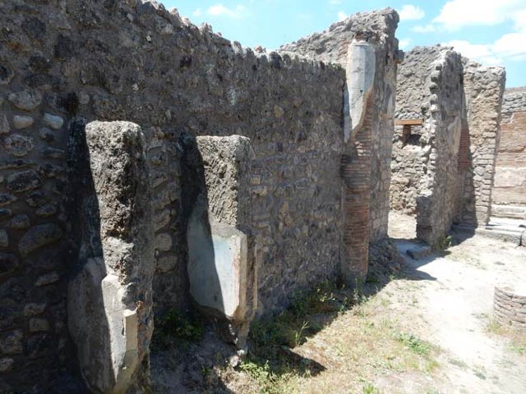 IX.2.27 Pompeii. May 2017.  Remains of shrine on wall of peristyle, looking north along west wall towards doorway to kitchen/latrine. Photo courtesy of Buzz Ferebee.