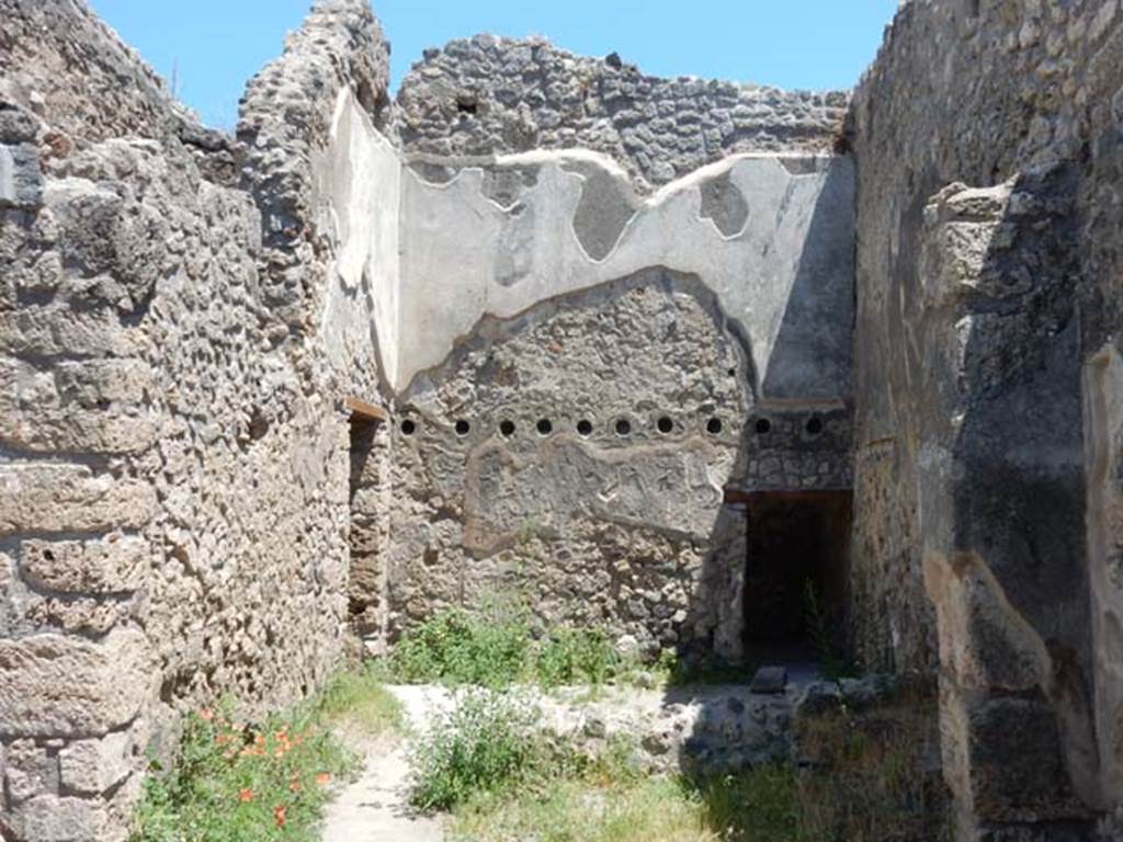 IX.2.27 Pompeii. May 2017. Looking east across room in south-east corner, with doorway to another room at the rear, on the right.  On the left is a doorway leading to the area under the stairs. Photo courtesy of Buzz Ferebee.