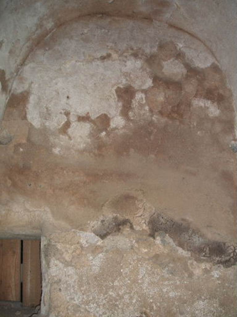 IX.2.27 Pompeii. May 2005. Remains of painted plaster from room on east side of peristyle.
According to Trendelenburg,
“Facing this room was the door of a room, (the triclinium) which preserved its stucco decoration: the zoccolo painted in the guise of marble, painted yellow panels with cupids and frieze of the same colour. The wall opposite the entrance also featured a painting of the noted representation of Narcissus sitting on a stone, below which was a pond in which was reflected his face. He supported his left arm on the stone and in his right hand held a spear, while a cupid looked towards him”. 
See Bullettino dell’Instituto di Corrispondenza Archeologica (DAIR), 1871, p. 178.