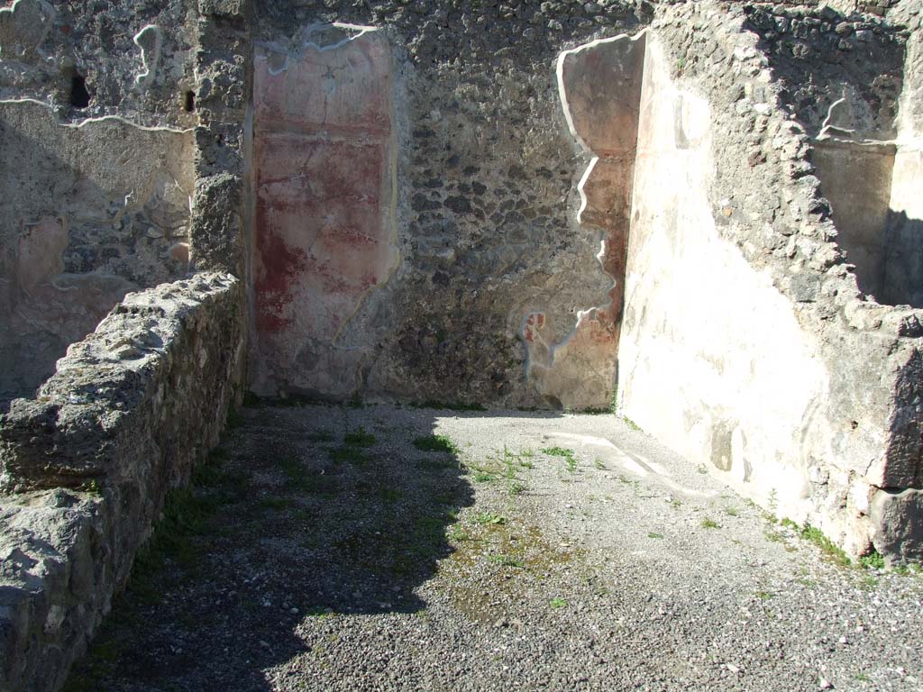 IX.3.2 Pompeii. March 2009. Exedra/ala on north side of former atrium.
This room would have had a white mosaic floor edged with a band of black mosaic, just visible in the north-east corner, (centre right of photo).