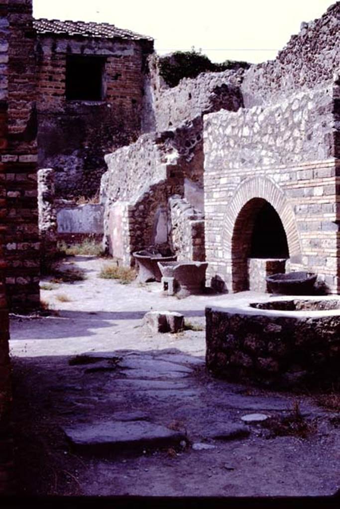 IX.3.12 Pompeii. 1966. Looking north-east across bakery from entrance doorway.  Photo by Stanley A. Jashemski.
Source: The Wilhelmina and Stanley A. Jashemski archive in the University of Maryland Library, Special Collections (See collection page) and made available under the Creative Commons Attribution-Non Commercial License v.4. See Licence and use details.
J66f0130