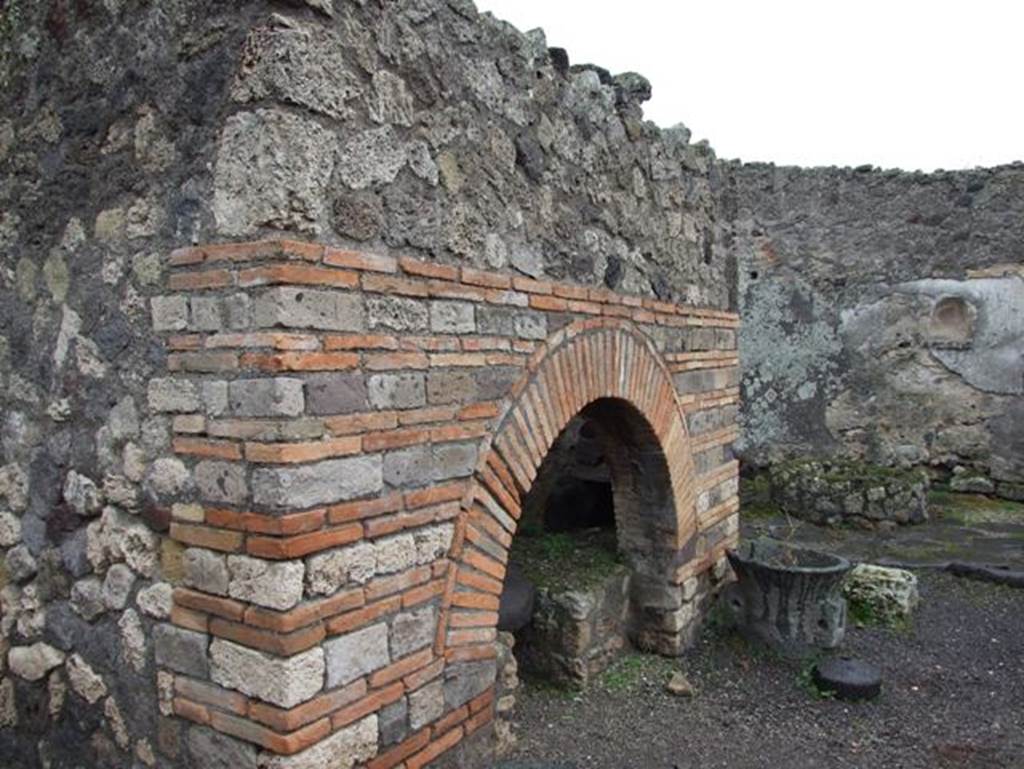 IX.3.12 Pompeii. January 2008. Looking across the front of the oven towards the south wall.