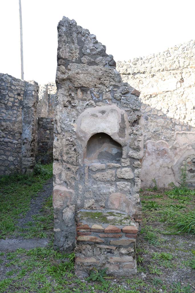 IX.3.14 Pompeii. December 2018. 
Niche and altar set into north wall of shop, between doorways.
Photo courtesy of Aude Durand.