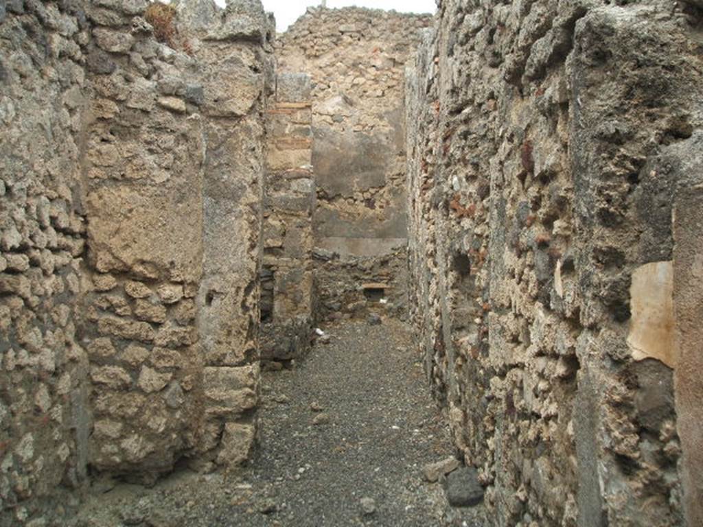 IX.3.14 Pompeii. May 2005. 
Corridor to rear on west side, which was only partly covered by a roof, containing the fusorium, hearth and the latrine.