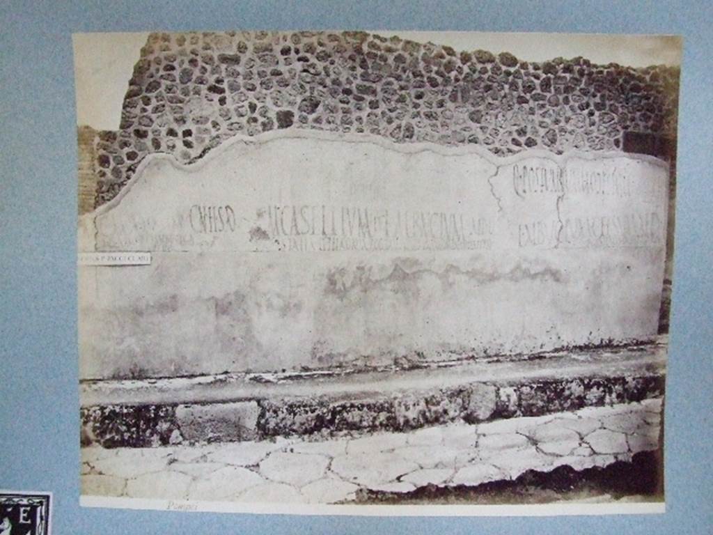 IX.3.19 Taberna T. Genialis.  Graffiti on wall between IX.3.18 and IX.3.19.  Old undated photograph courtesy of the Society of Antiquaries, Fox Collection.