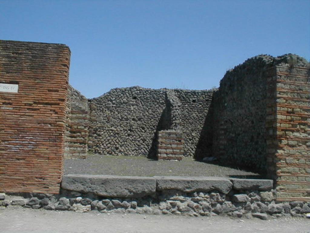 IX.4.1 Pompeii. May 2005. Entrance, looking east from Via Stabiana, towards rear rooms. 
According to Maiuri, three of the shops on the corner of this insula, appear to have had an elevated threshold of at least 0.80m above the floor of the sidewalk and what should have been the original threshold. They clearly distinguish the brickwork/masonry of the above elevation from the original floor of the threshold. In the third taberna (from the corner of the quadrivium) IX.4.3, only one block of the threshold appears located in its place.
See Maiuri, A, (2002): L’ultima fase edilizia di Pompei, Arte Tipografica, Naples, (p.75, note 3).
.