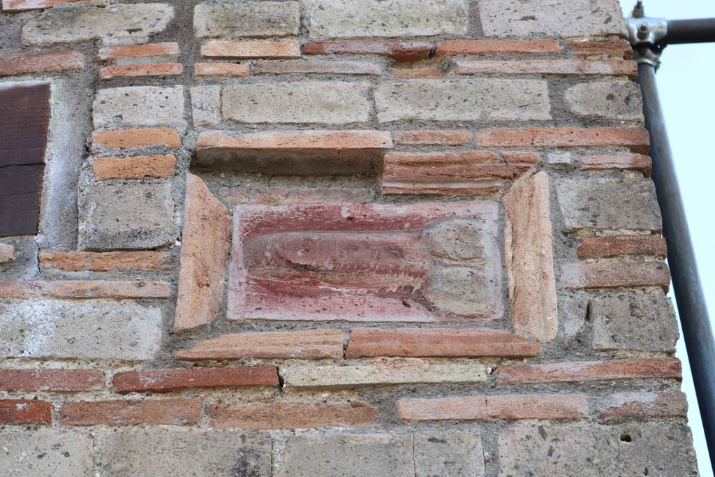 IX.5.1 Pompeii. December 2018. 
Terracotta wall plaque of phallus on wall on west side of entrance doorway. Photo courtesy of Aude Durand.