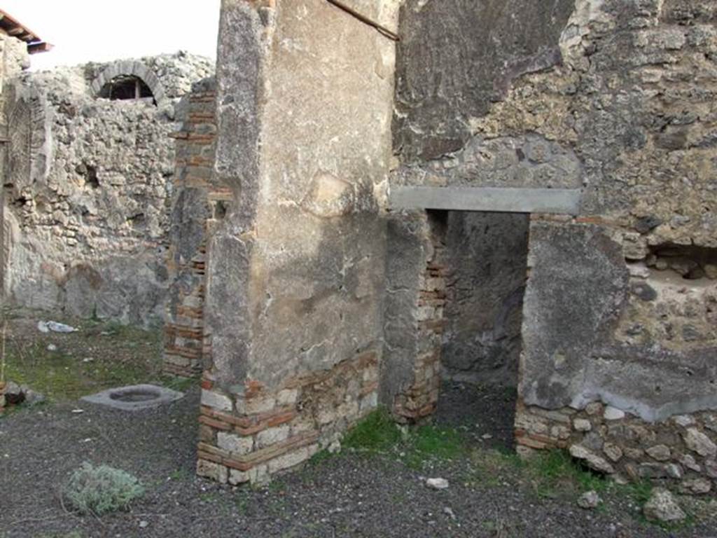 IX.5.2 Pompeii. December 2007. Room ‘v’, large exedra. 
Looking north-east to peristyle ‘p’ (on left) and small door in east wall of corner of room ‘v’ into corridor leading to rooms ‘x’ and ‘y’.