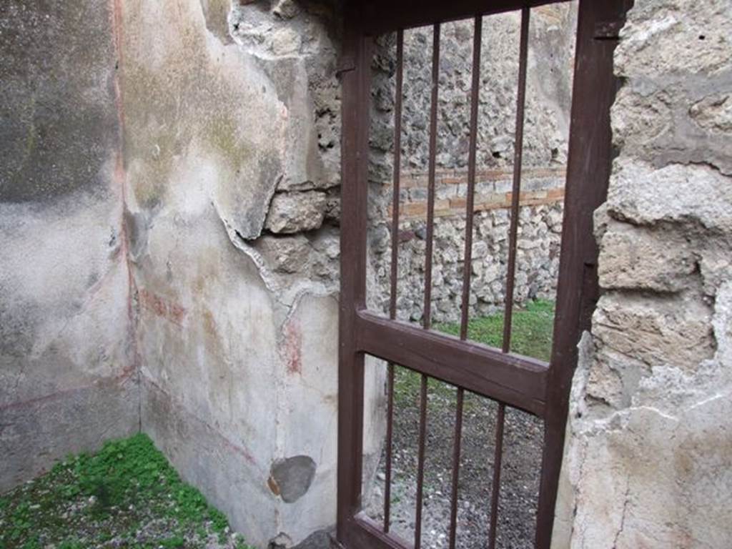 IX.5.2 Pompeii. December 2007. Room 5, north wall in north-west corner, with doorway to IX.5.1.