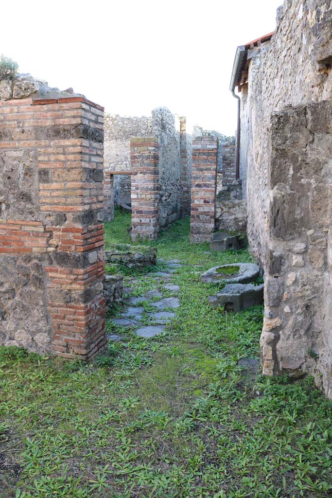 IX.5.4 Pompeii. December 2018. 
Looking south from shop into bakery area. Photo courtesy of Aude Durand.