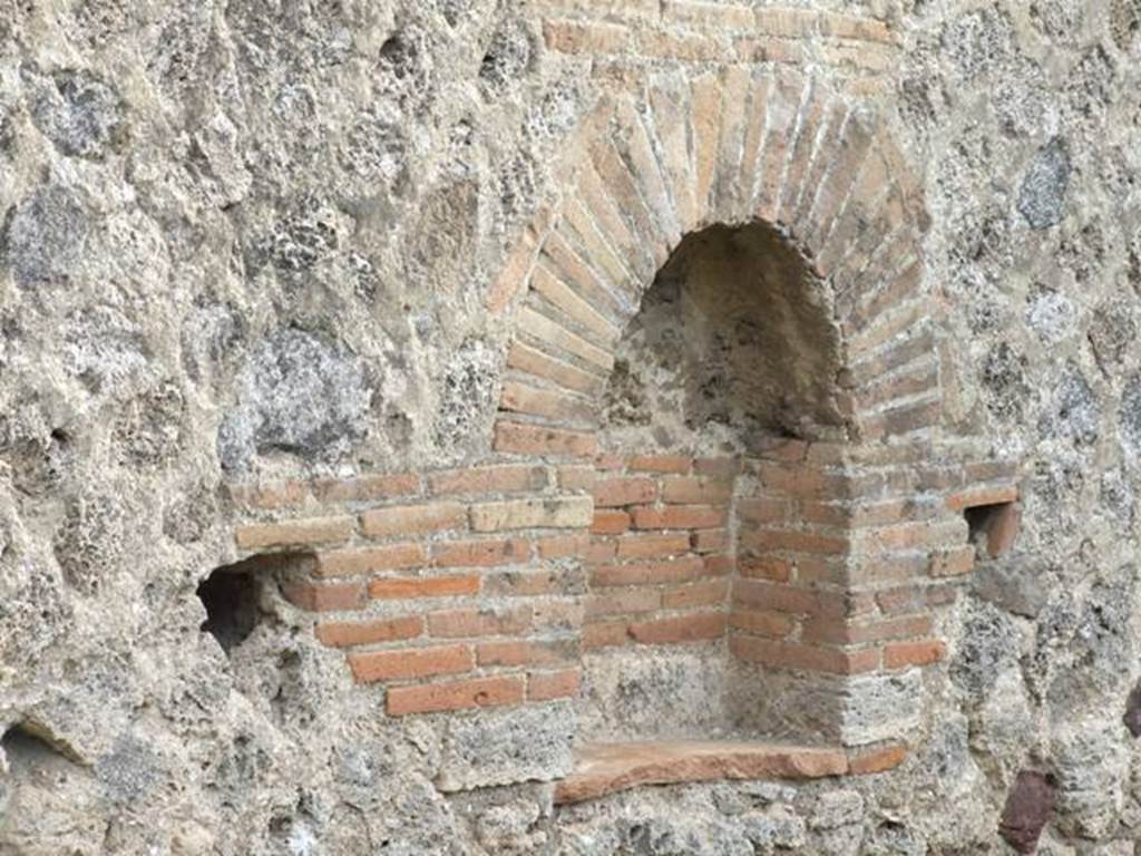 IX.5.6 Pompeii. December 2007. Room u, niche on east wall in garden area.  
According to Boyce, Mau measured this arched niche as h.0.31, w.0.39, d.019.
In 1937 Boyce said the niche measured h.0.70, w.0.60, d.0.20.
He felt that such a discrepancy could not be explained by the falling away of the coating of plaster which had left the bricks quite bare.
In front of the niche stood a small masonry altar.
He gave the references – Not. Scavi, 1878, 262; Bull. Inst., 1879, 94; Overbeck-Mau, 290.
See Boyce G. K., 1937. Corpus of the Lararia of Pompeii. Rome: MAAR 14. (p.85, no. 422) 
See Giacobello, F., 2008. Larari Pompeiani: Iconografia e culto dei Lari in ambito domestico. Milano: LED Edizioni, (p.285 no.V80)