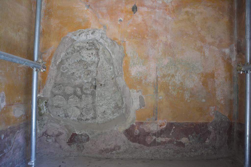 IX.5.6 Pompeii. May 2017. Room h, lower west wall, with hole made by tunnellers.  
Foto Christian Beck, ERC Grant 681269 DÉCOR.
According to PPM –
The central painting (0.34 x 0.34) showed a sitting Pan with a crown of pine, leather skin on his back and pedum in his left hand, about to discover a sleeping Maenad, next to whom lie the thyrsus and a tambourine.
See Carratelli, G. P., 1990-2003. Pompei: Pitture e Mosaici. Roma: Istituto della enciclopedia italiana, (p.435).
According to Sogliano - On the west wall was a painting of Pan discovering a Bacchante.
See Sogliano, A., 1879. Le pitture murali campane scoverte negli anni 1867-79. Napoli: Giannini. (p.44, no.195).