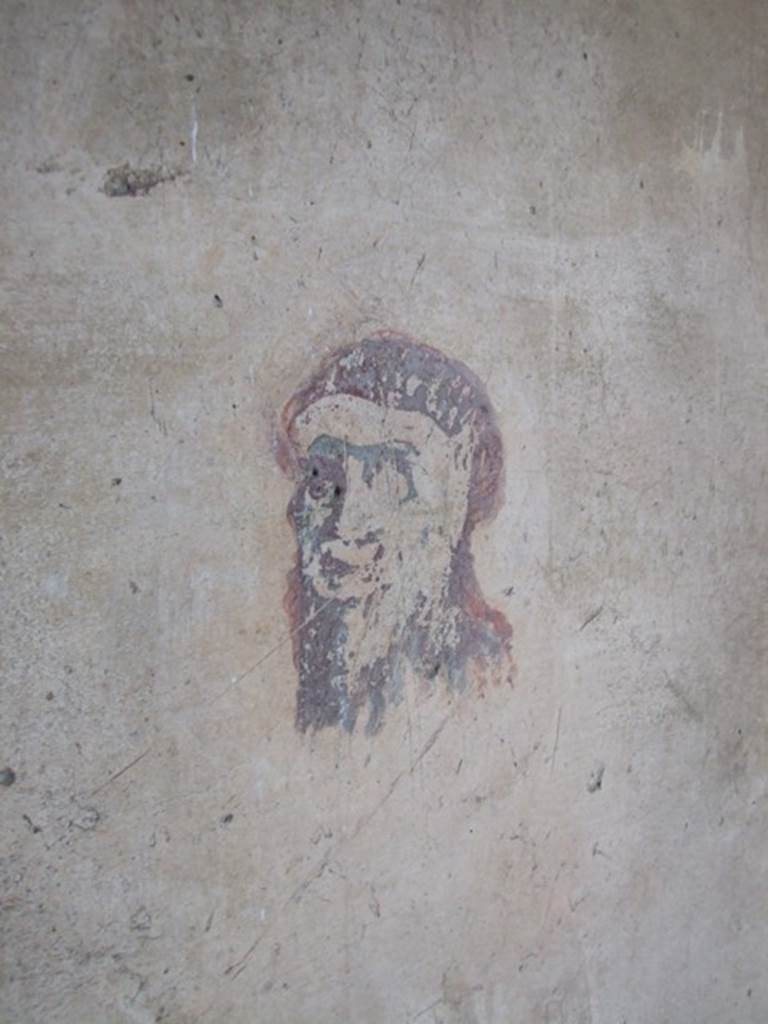 IX.5.6 Pompeii. December 2007.  Room 8, wall painting of a head or mask in corridor on east side of tablinum.