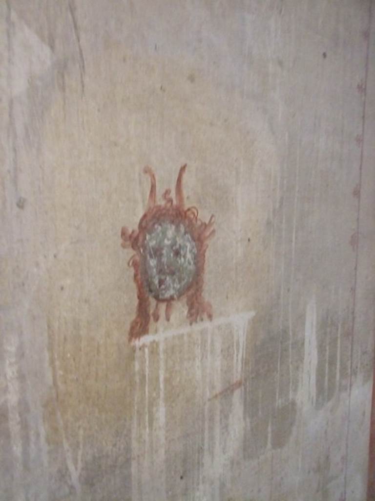 IX.5.6 Pompeii. December 2007. 
Room k’, wall painting of a head or mask from south end in corridor on west wall.