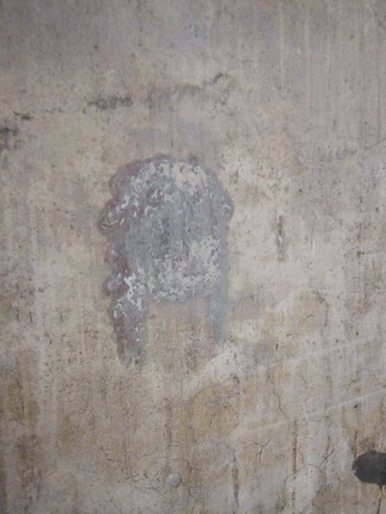 IX.5.6 Pompeii. December 2007. 
Room k, wall painting of a head or mask at north end of corridor on west wall.