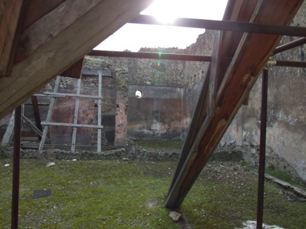 IX.5.9 Pompeii. December 2007. Looking south across peristyle “i” to doorway of room “o” with wooden scaffolding and room “p” in corner.