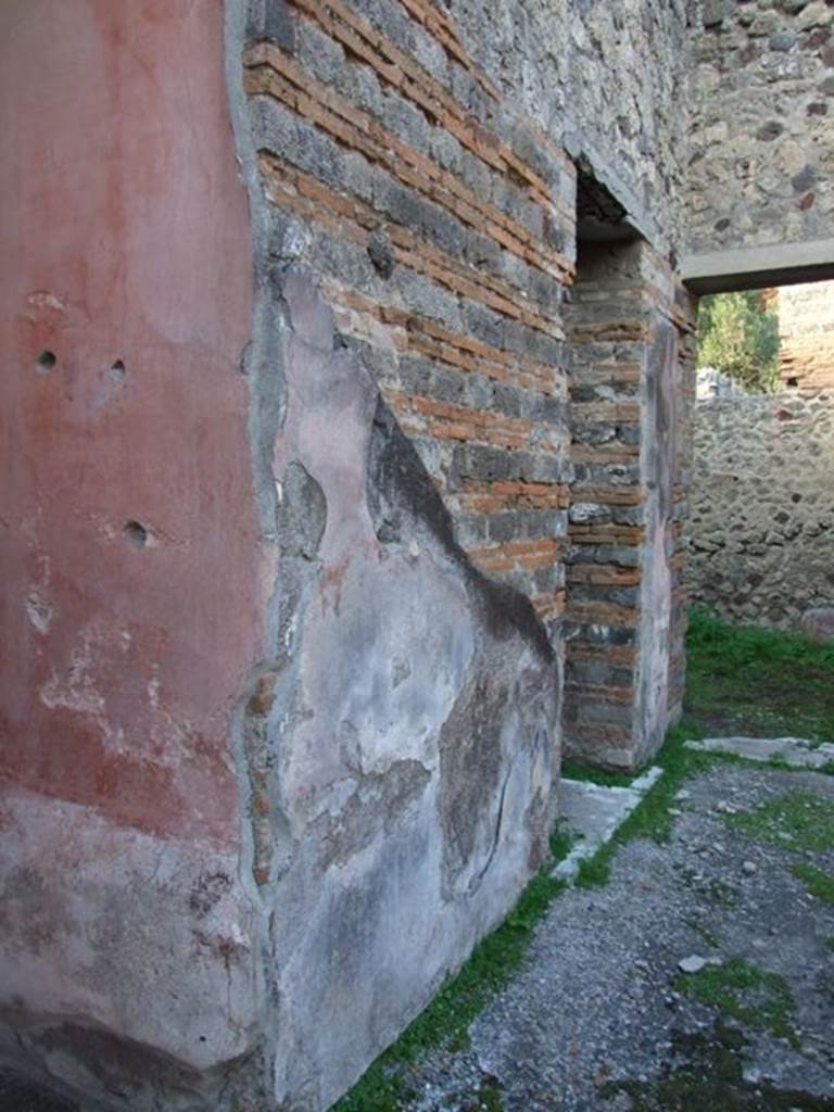 IX.5.11 Pompeii. December 2007. Looking north-west.
Room 8, north-east corner of ala and atrium wall, with doorways to rooms 9 and 10.
Mau thought that, almost certainly, on this pilaster facing onto the atrium would have been a personification of either autumn or winter, as was seen on the pilasters between rooms 3 and 4, and 7 and 8.  
See Bullettino dell’Instituto di Corrispondenza Archeologica (DAIR), 1879 (p.197).
