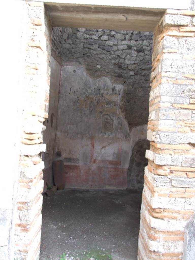 IX.5.11 Pompeii. December 2007. Doorway to room 2, a cubiculum, looking east. The walls of this room would have had a red zoccolo divided into panels by narrow compartments containing painted plants. In the white panels of the middle zone were vignettes with cupids, the upper zone was also white with a stucco cornice.