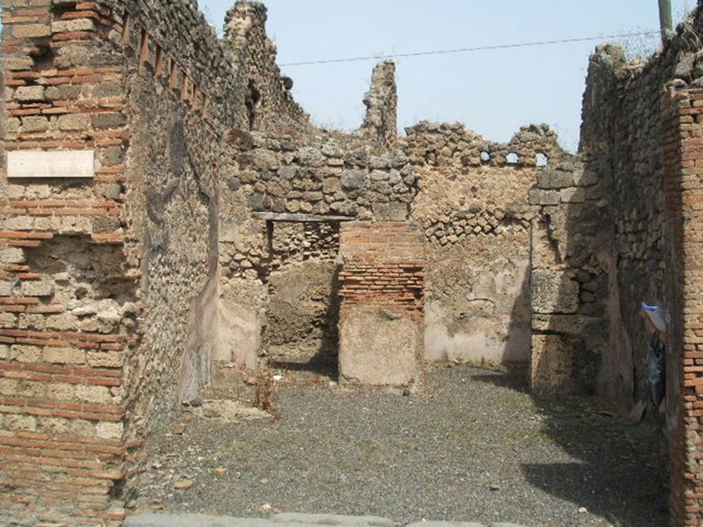 IX.6.a Pompeii. May 2005. Entrance doorway, looking north across large shop-room.
According to Eschebach, on the left was the hearth and steps to upper floor, with latrine beneath. See Eschebach, L., 1993. Gebäudeverzeichnis und Stadtplan der antiken Stadt Pompeji. Köln: Böhlau. (p.428)
According to Flohr, see below, the stairs were in the rear room. This room identified as a shop or workshop had never been identified as a fullonica prior to his excavation in the north-west corner of the shop-room. The remains of the two low walls and a small platform, with space between the walls were thought to have been fulling stalls. Surface cleaning around the possible fulling installation confirmed the hypothesis.
See Rivista di Studi, XVIII, 2007, article by Flohr, M, entitled Cleaning the laundries report of the 2006 season, (p.134)
According to Mau, this was a shop with two rooms, one of them having a separate entrance from the western vicolo (IX.6.1). The shop and the room to the right had walls painted with a high flesh-coloured zoccolo (plinth); in the other room the plaster was not conserved.
See Mau in BdI 1881, (p.32), (described as number 14).
According to Varone, CIL IV 5203, 5204 and 5206 were found on the wall between IX.6.a and IX.6.b (see IX.6.b for details).
See also Mau in BdI 1881, (p.32)