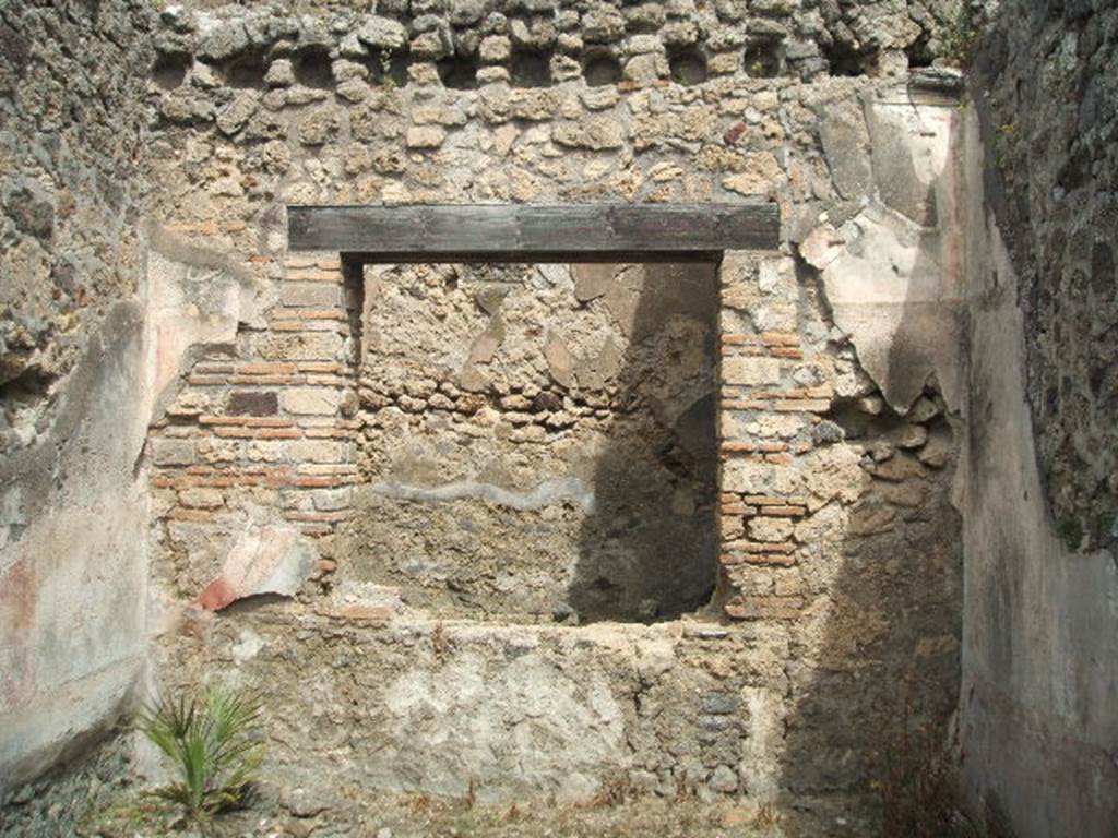 IX.6.d Pompeii. May 2005. North wall of triclinium “e” with window into light-yard, or courtyard “h”. Found on the north wall on either side of the window were wall paintings of Sirens, one with lyre, the other with flute.
See Schefold, K., 1957. Die Wande Pompejis. Berlin: De Gruyter. (p.267)
See Sogliano, A., 1879. Le pitture murali campane scoverte negli anni 1867-79. Napoli: (p.71, nos.427 and 428)
In the courtyard “h”, were two basins leaning against the west and north walls (2,15 long, 0,65 and 0,75 wide, and 0,60 high), each with a drain in its floor. In the south-east corner was a large hollow 0,35 x 0,42, 0,30 deep. There was also a fragment of a terracotta puteal and the lower half of a broken amphora filled with lime. The window between ' e ' and ' h ' (1.59 high, 1.66 long) was closed by two shutters; the sockets of the hinges were conserved. 
See BdI 1881, p. 30.