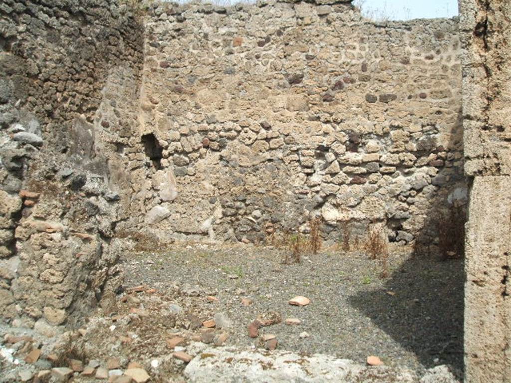 IX.6.f Pompeii. May 2005. Looking north across shop. According to Mau, this was described as number 9 of IX.6, and was a shop. In the corner to the left of the entrance was a cupboard (or small area), divided from the rest of the shop by a partition. On the walls of it – but not on the most recent road wall – were preserved remains of 1st style decoration: a red zoccolo (plinth), a little sunk in relation to the white surface of the upper wall.
See Mau in BdI, 1881, p.25