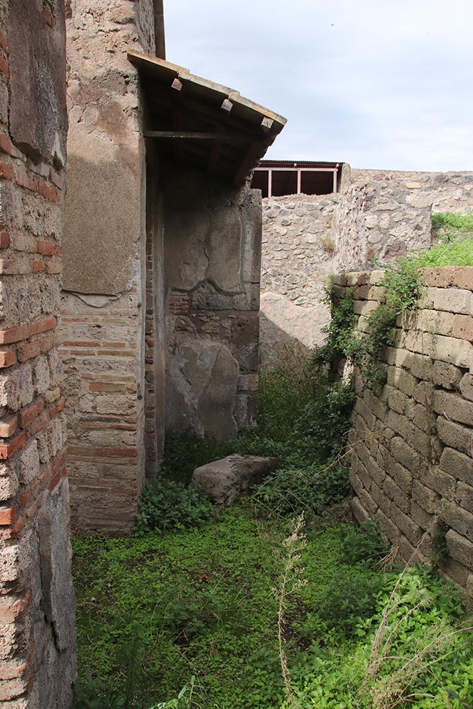 IX.7.16 Pompeii. October 2024. 
Looking north across atrium 2, towards north-west corner, with doorway to room “a”, under roof, and doorway into room 7.
The entrance corridor 1 is on left. Photo courtesy of Klaus Heese.