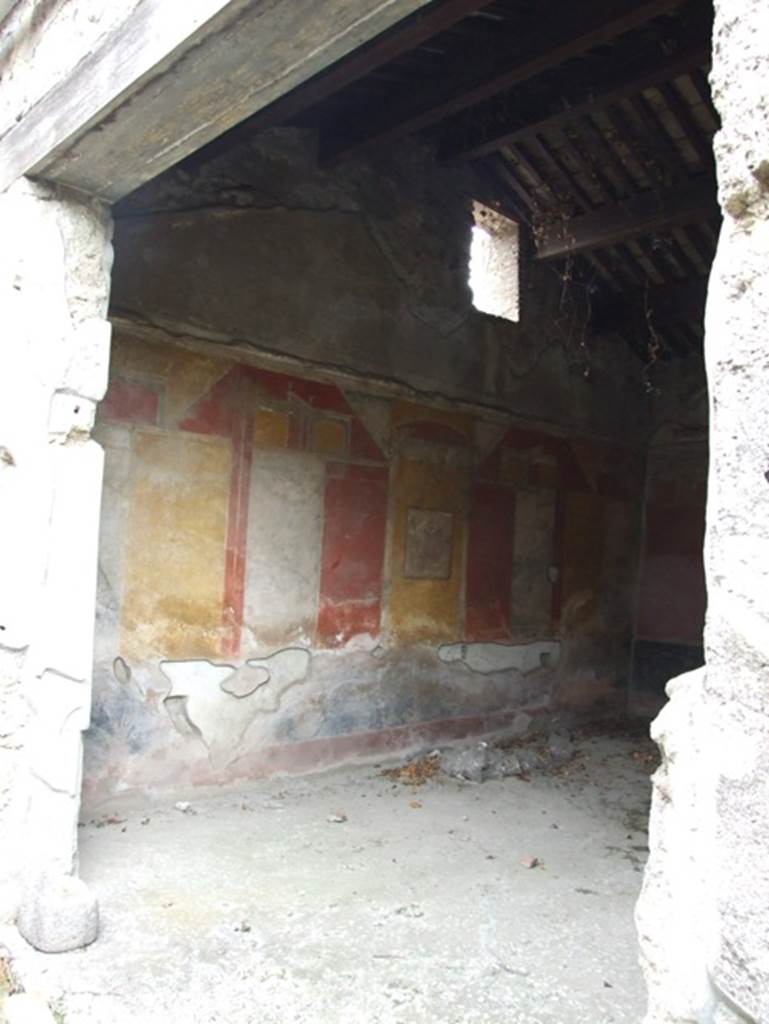 IX.7.20 Pompeii. December 2007. Looking east through doorway into large triclinium (room i) on south side of peristyle. 
According to Peters, this was a late Third Style decorated triclinium, that Schefold had dated to “under Vespasian”.
See Peters, W.J.T. (1963): Landscape in Romano-Campanian Mural Paintings. The Netherlands, Van Gorcum. (p.108)
See Bragantini, de Vos, Badoni, 1986. Pitture e Pavimenti di Pompei, Parte 3. Rome: ICCD. (p.504-506)